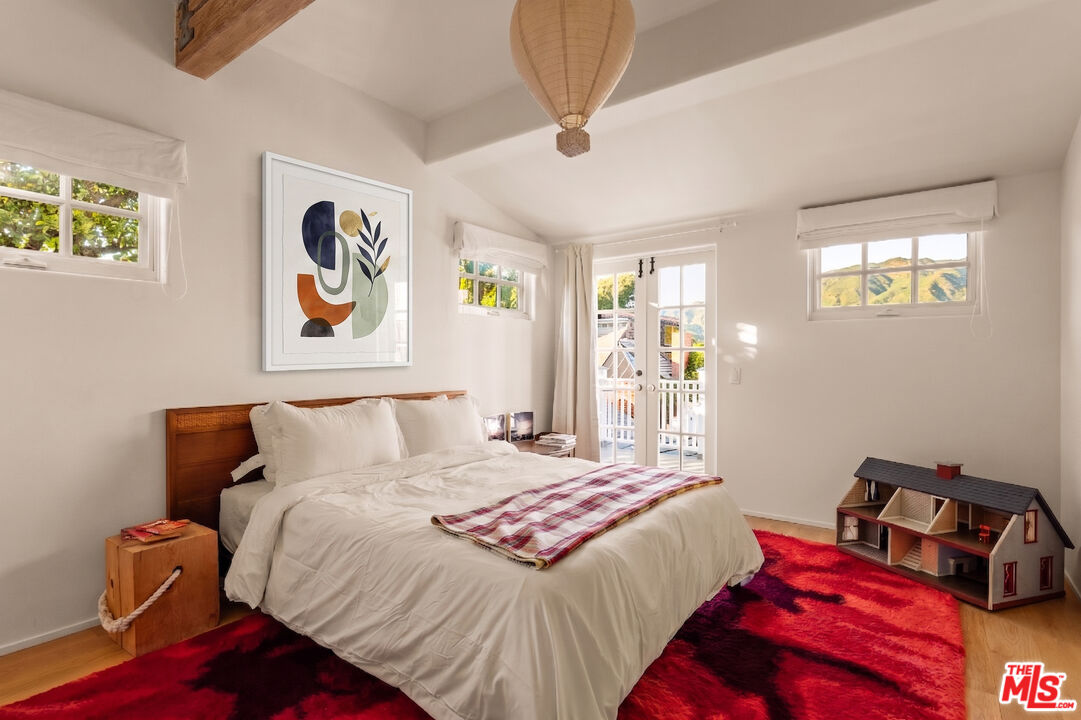 23422 Malibu Colony Road, Unit 98 Malibu, CA 90265 - Photo 15 of 42 a bedroom with a bed and painting on the wall