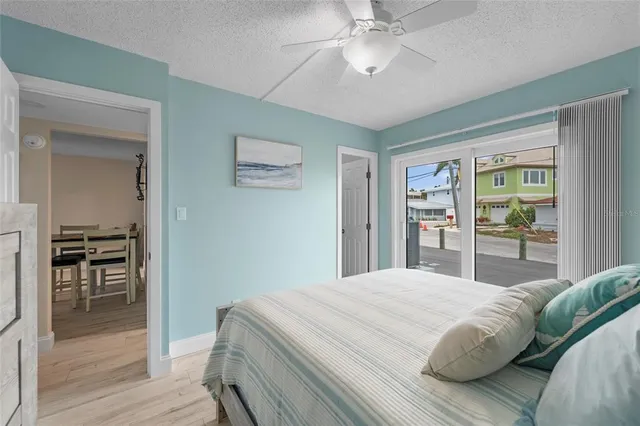 a bedroom with a large bed and a chandelier