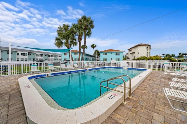 a view of a swimming pool with a patio
