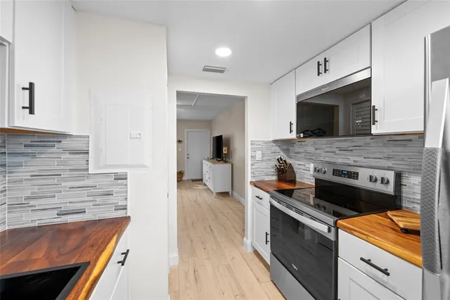 a kitchen with granite countertop stainless steel appliances and wooden cabinets