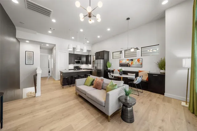 a living room with furniture and kitchen view
