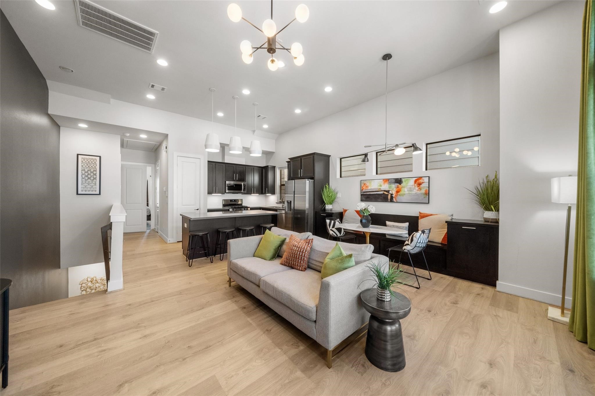 a living room with furniture and kitchen view