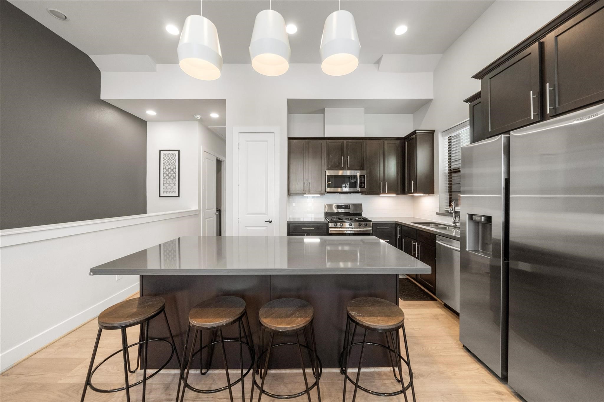 2616 Riverside Drive, Unit M Houston, TX 77004 - Photo 14 of 28 a kitchen with granite countertop a counter space cabinets stainless steel appliances and cabinets