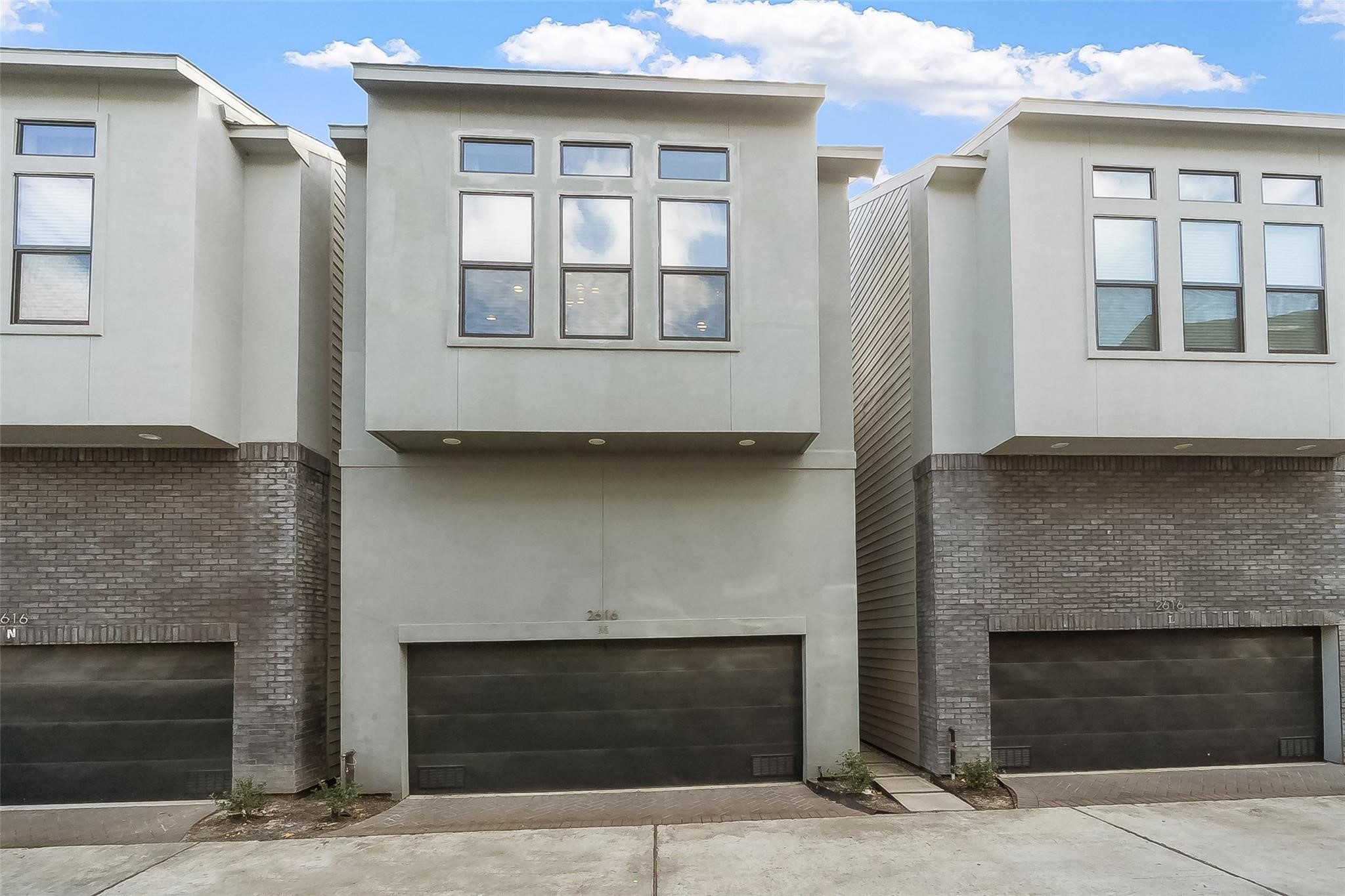 2616 Riverside Drive, Unit M Houston, TX 77004 - Photo 2 of 28 a living room with a fireplace and windows