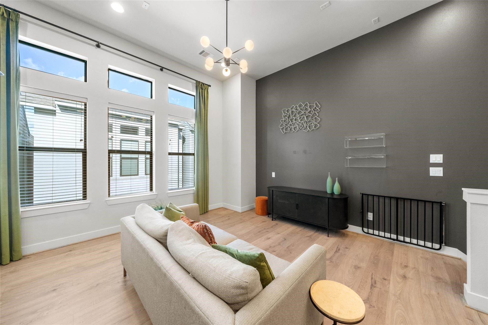 2616 Riverside Drive, Unit M Houston, TX 77004 - Photo 7 of 28 a living room with furniture and a chandelier