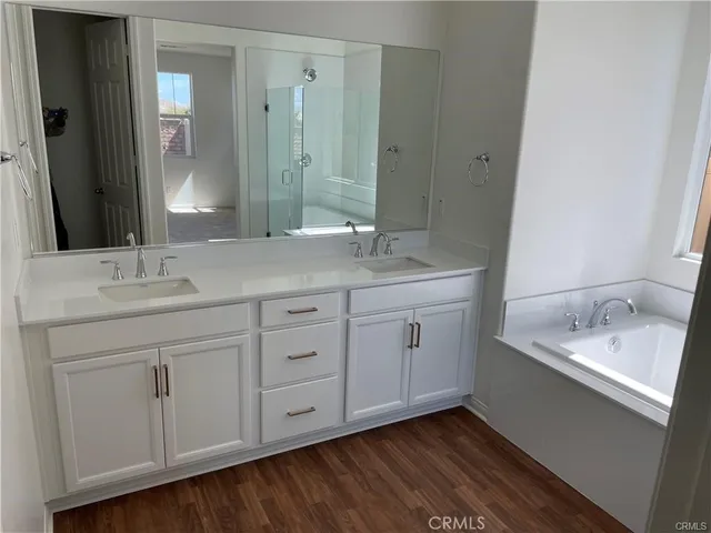 a bathroom with a granite countertop sink double and mirror