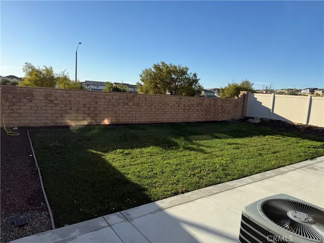 a swimming pool with outdoor seating and yard