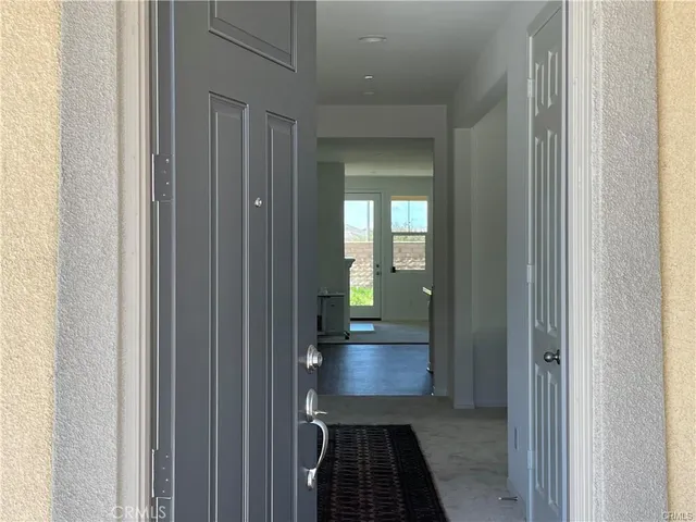 a view of a hallway view with wooden floor and a bathroom