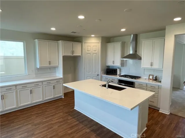 a kitchen with wooden cabinets and white appliances