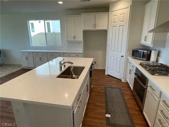 a kitchen with a sink a stove and refrigerator