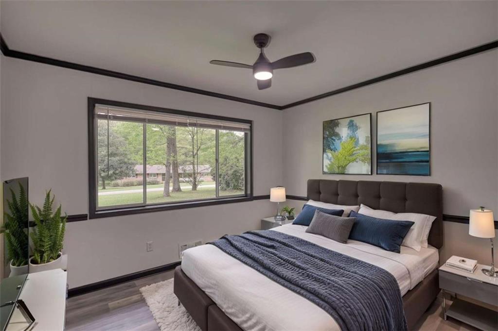 555 Joy Street Jackson, GA 30233 - Photo 35 of 56 a spacious bedroom with a large bed and a large window