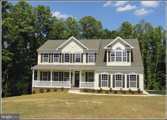 3230 Saber Road Huntingtown, MD 20639 - Photo 1 of 5 a front view of a house with a yard