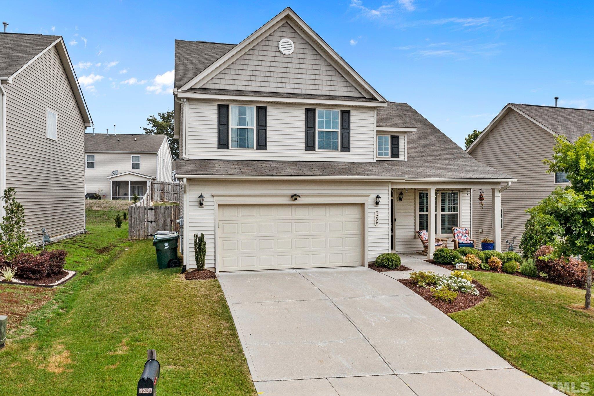 3229 Revelation Street Raleigh, NC 27610 - Photo 2 of 45 a front view of a house with a yard and potted plants