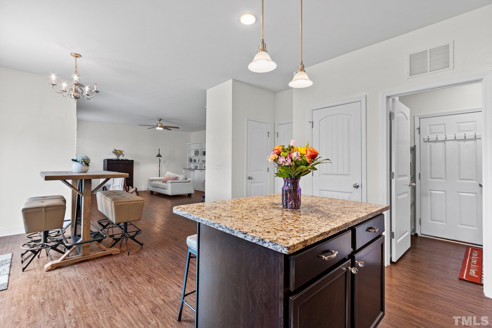 3229 Revelation Street Raleigh, NC 27610 - Photo 23 of 45 a view of a kitchen with dining table appliances and wooden floor