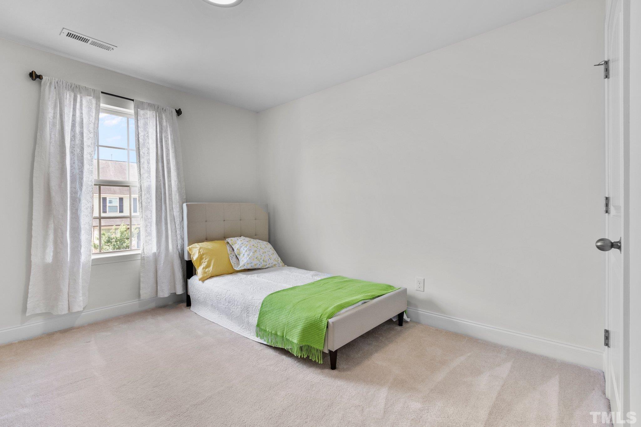 3229 Revelation Street Raleigh, NC 27610 - Photo 28 of 45 a bedroom with a bed lamp and window