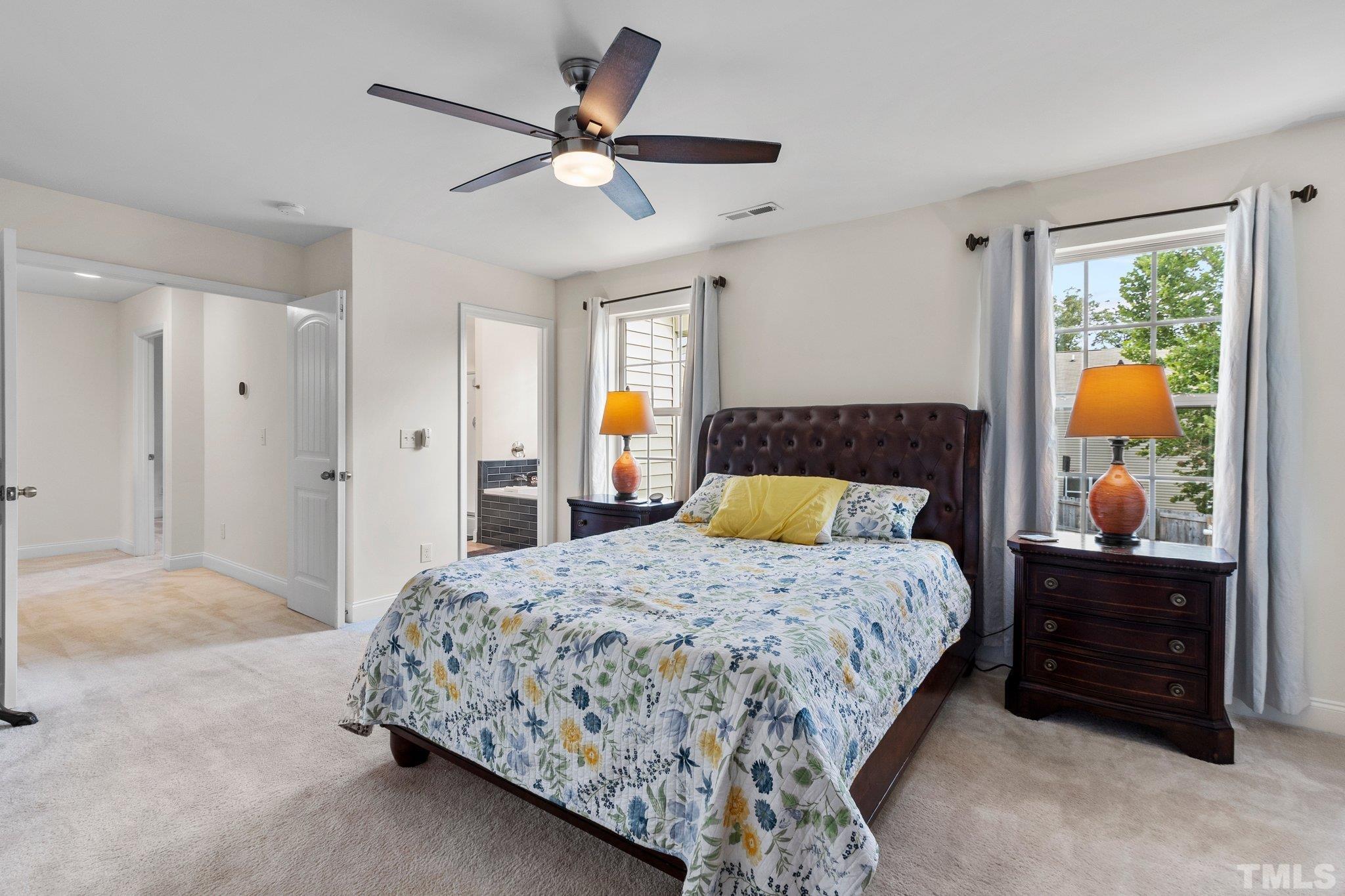 3229 Revelation Street Raleigh, NC 27610 - Photo 32 of 45 a bedroom with a large bed and a chandelier