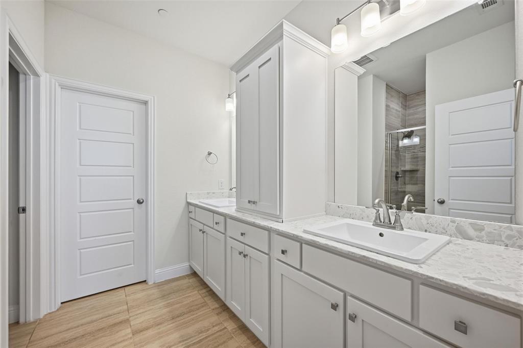 4624 Piedras Lanzar Drive McKinney, TX 75070 - Photo 12 of 20 a bathroom with a sink and a mirror