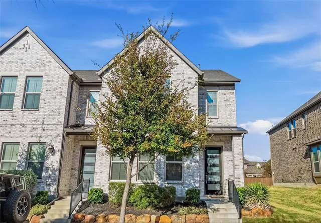 front view of a house with a tree