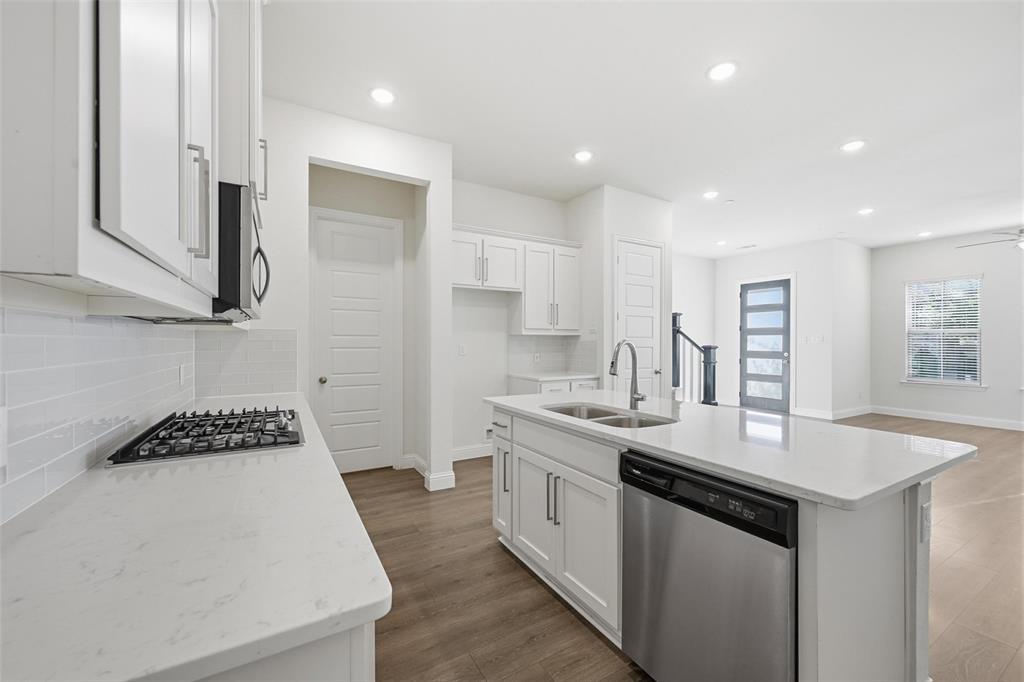 4624 Piedras Lanzar Drive McKinney, TX 75070 - Photo 7 of 20 a kitchen with stainless steel appliances a sink stove and cabinets