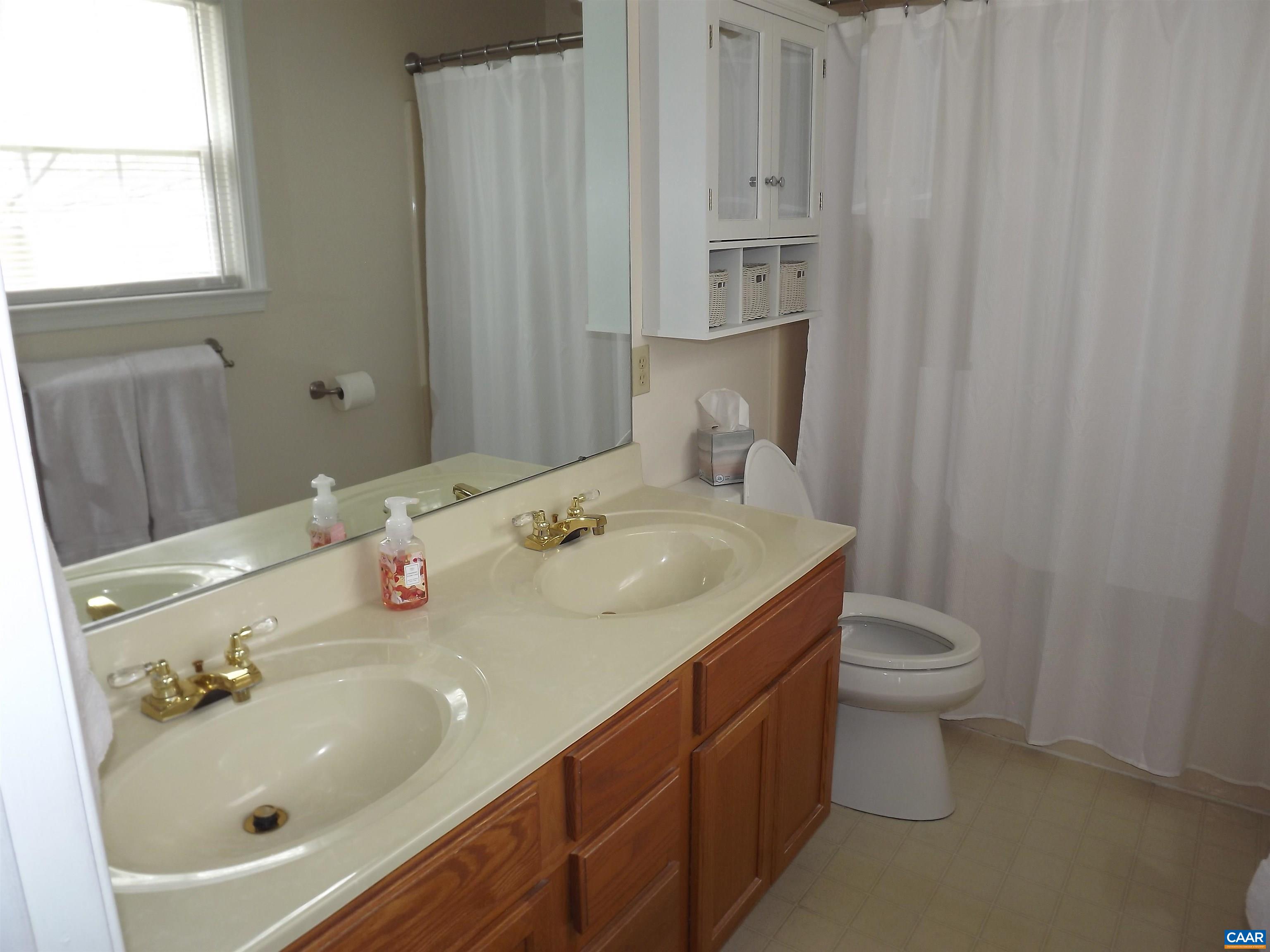 16 Powhatan Road Palmyra, VA 22963 - Photo 24 of 30 a bathroom with a sink toilet and mirror