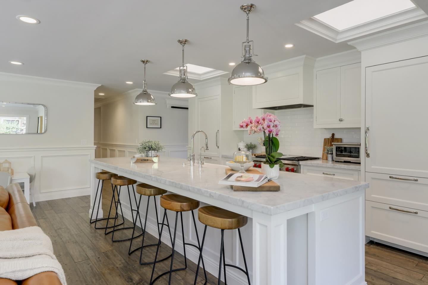 1261 Springer Road Los Altos, CA 94024 - Photo 16 of 32 a kitchen with kitchen island granite countertop a table a chandelier and living room view
