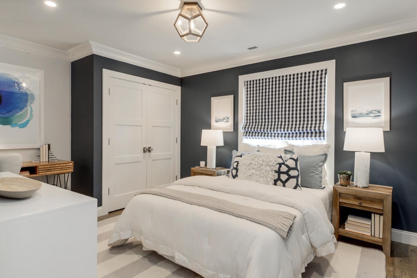 1261 Springer Road Los Altos, CA 94024 - Photo 24 of 32 a bedroom with a bed and a chandelier