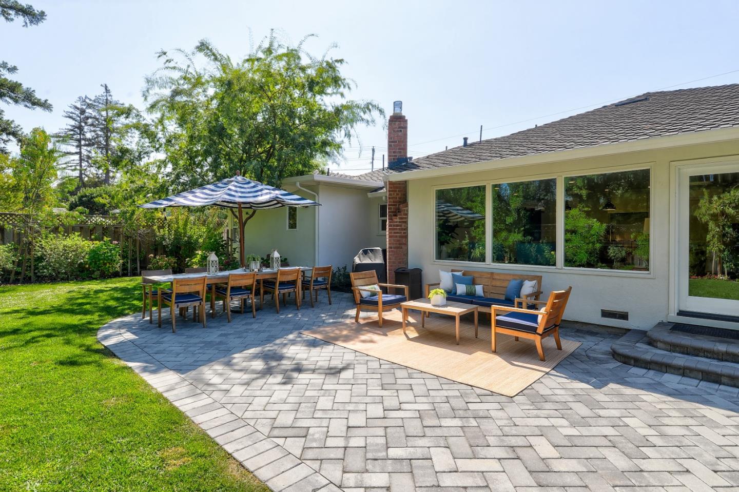 1261 Springer Road Los Altos, CA 94024 - Photo 28 of 32 a view of a patio with table and chairs under an umbrella