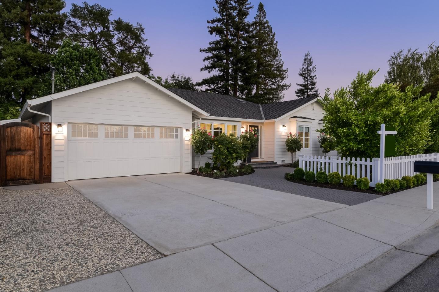 1261 Springer Road Los Altos, CA 94024 - Photo 4 of 32 a view of a small yard in front of a house with a large tree and wooden fence