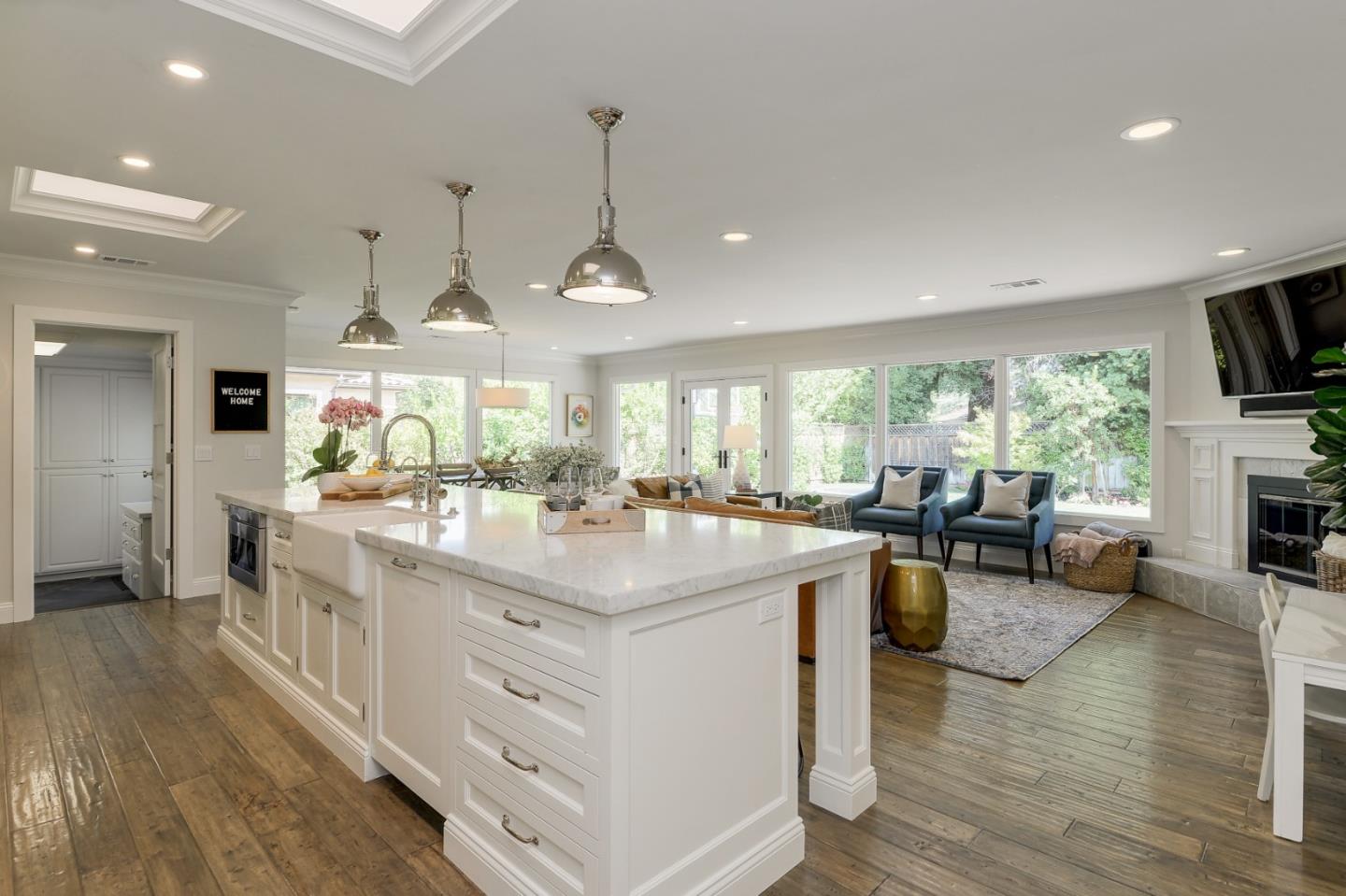1261 Springer Road Los Altos, CA 94024 - Photo 9 of 32 a kitchen with stainless steel appliances granite countertop a stove and a large countertops with wooden floor