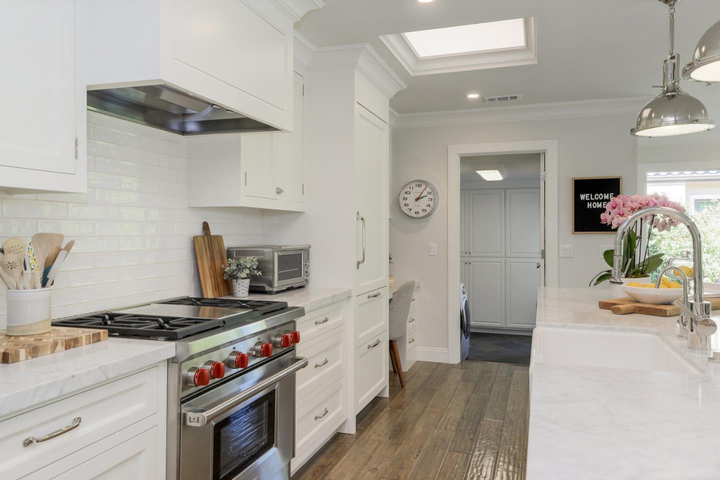 1261 Springer Road Los Altos, CA 94024 - Photo 10 of 32 a kitchen with stainless steel appliances a stove and white cabinets