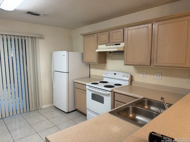 a kitchen with a stove and a refrigerator