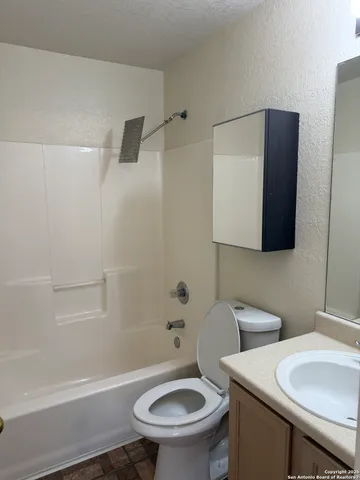 a bathroom with a toilet a sink and bathtub