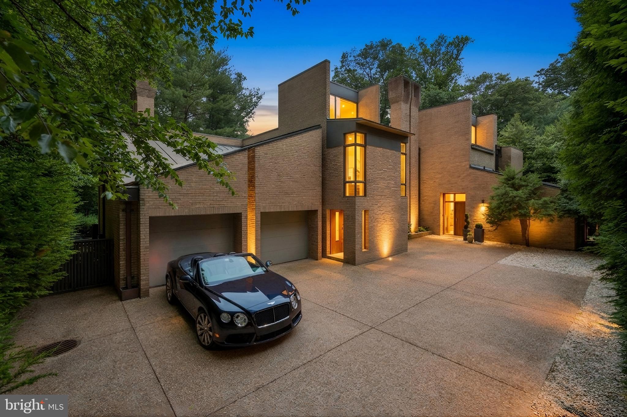 400 Chain Bridge Road McLean, VA 22101 - Photo 1 of 31 a car parked in front of a brick house