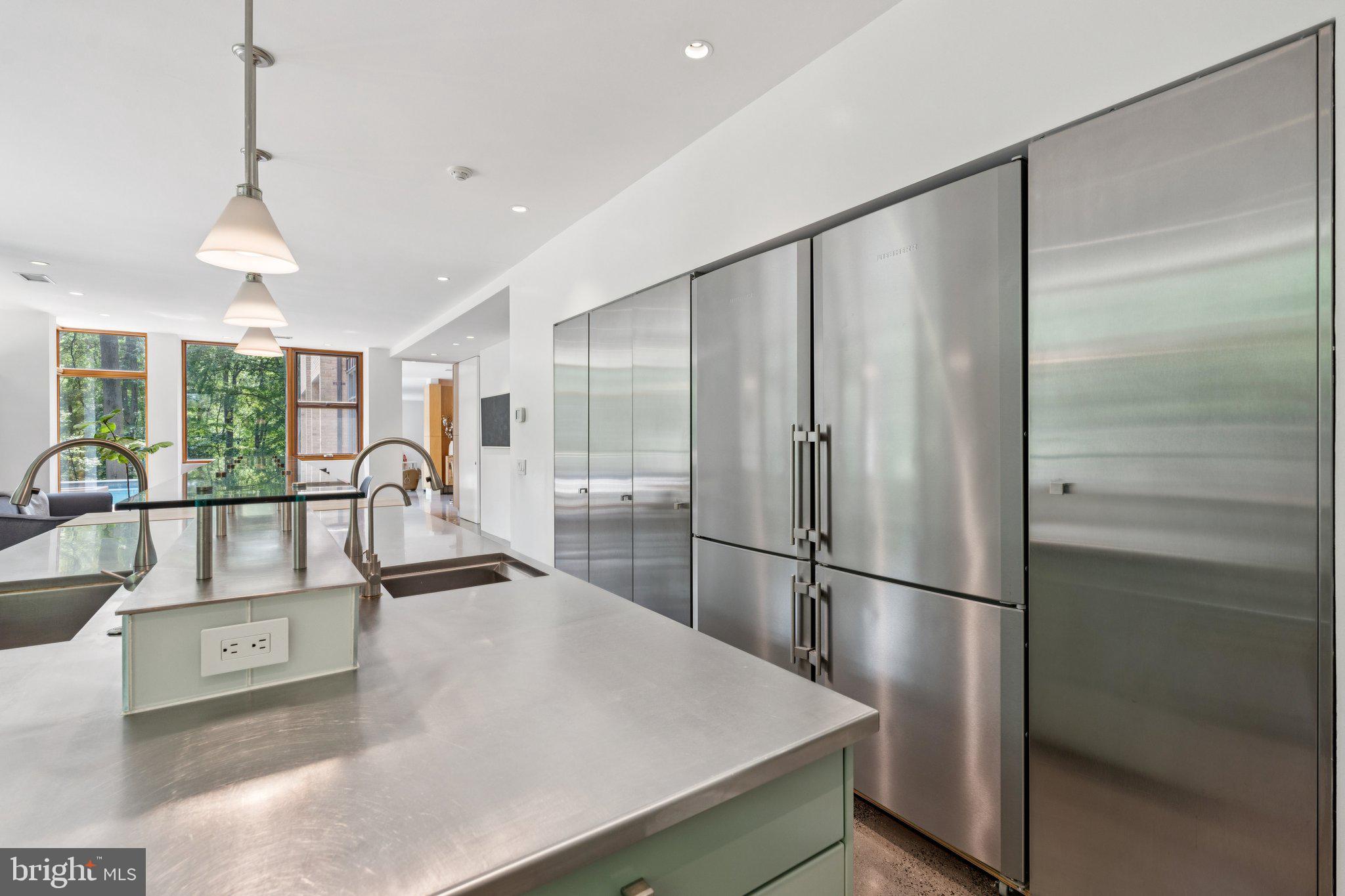 400 Chain Bridge Road McLean, VA 22101 - Photo 11 of 31 a kitchen with stainless steel appliances granite countertop a refrigerator a stove and a sink with wooden floor