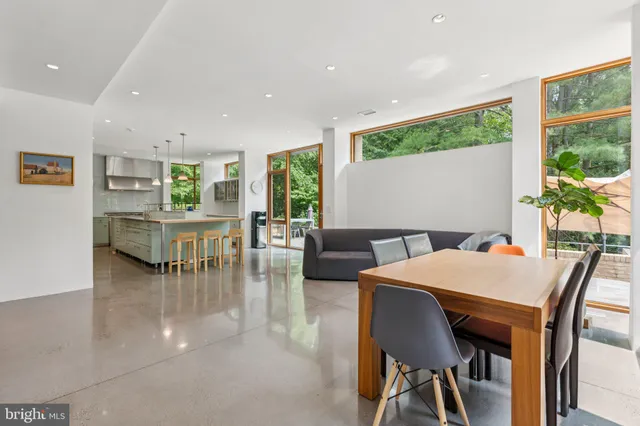 a dining room with furniture and a floor to ceiling window