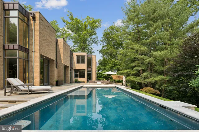 a swimming pool with outdoor seating and yard