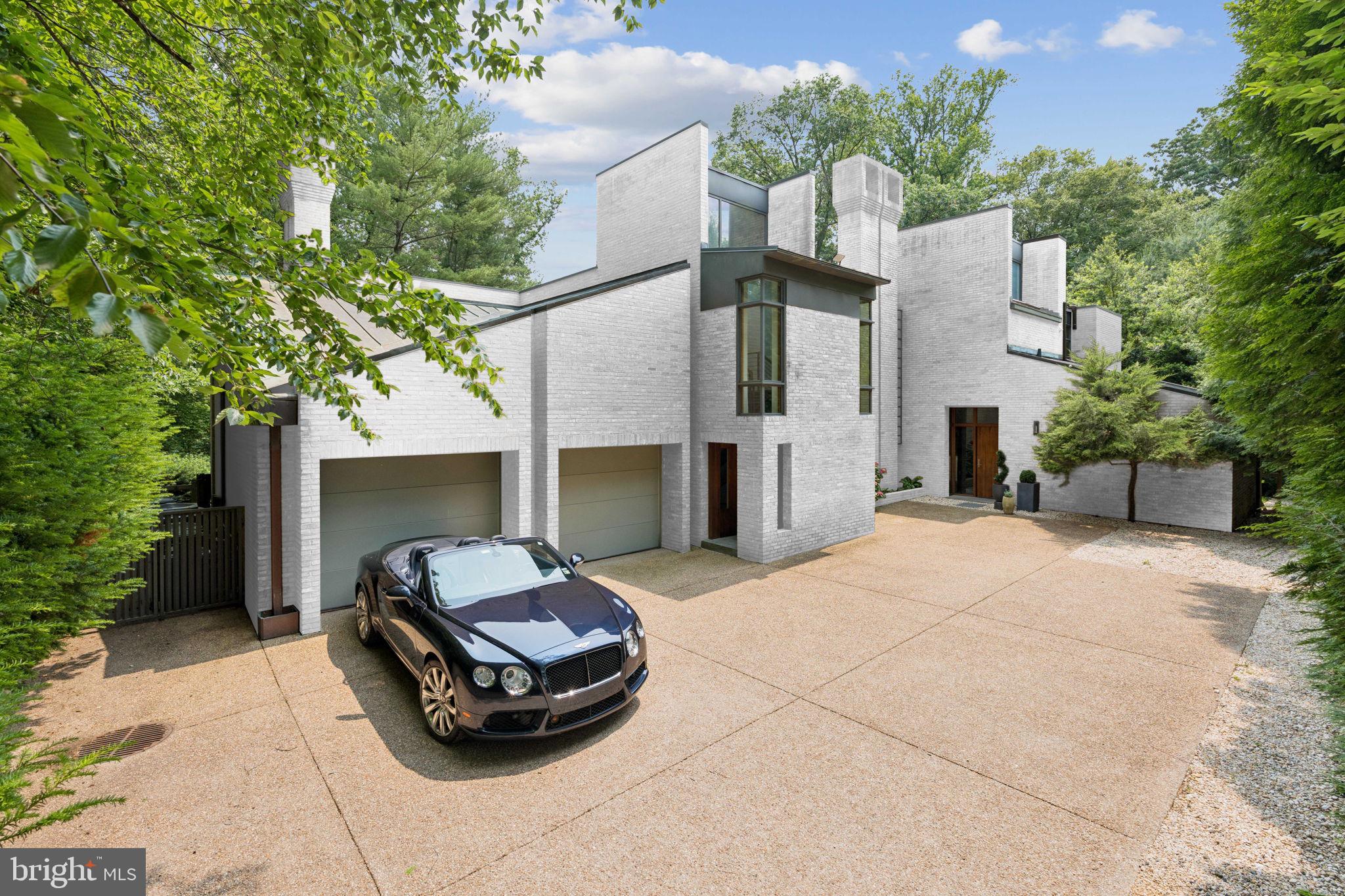 400 Chain Bridge Road McLean, VA 22101 - Photo 3 of 31 a car parked in front of house with a yard