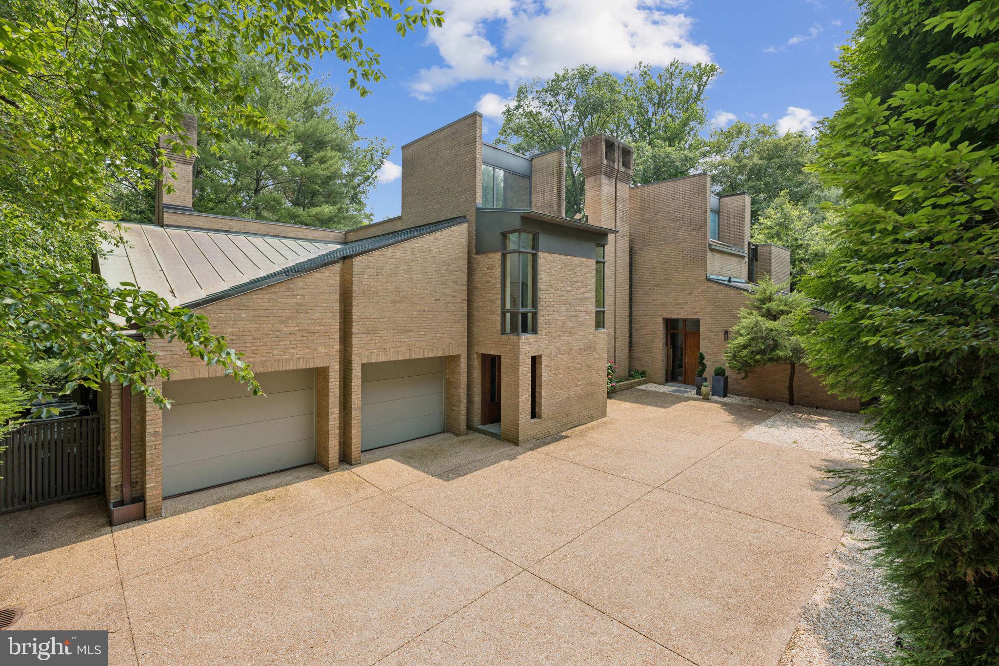 400 Chain Bridge Road McLean, VA 22101 - Photo 4 of 30 a view of a house with a yard and garage