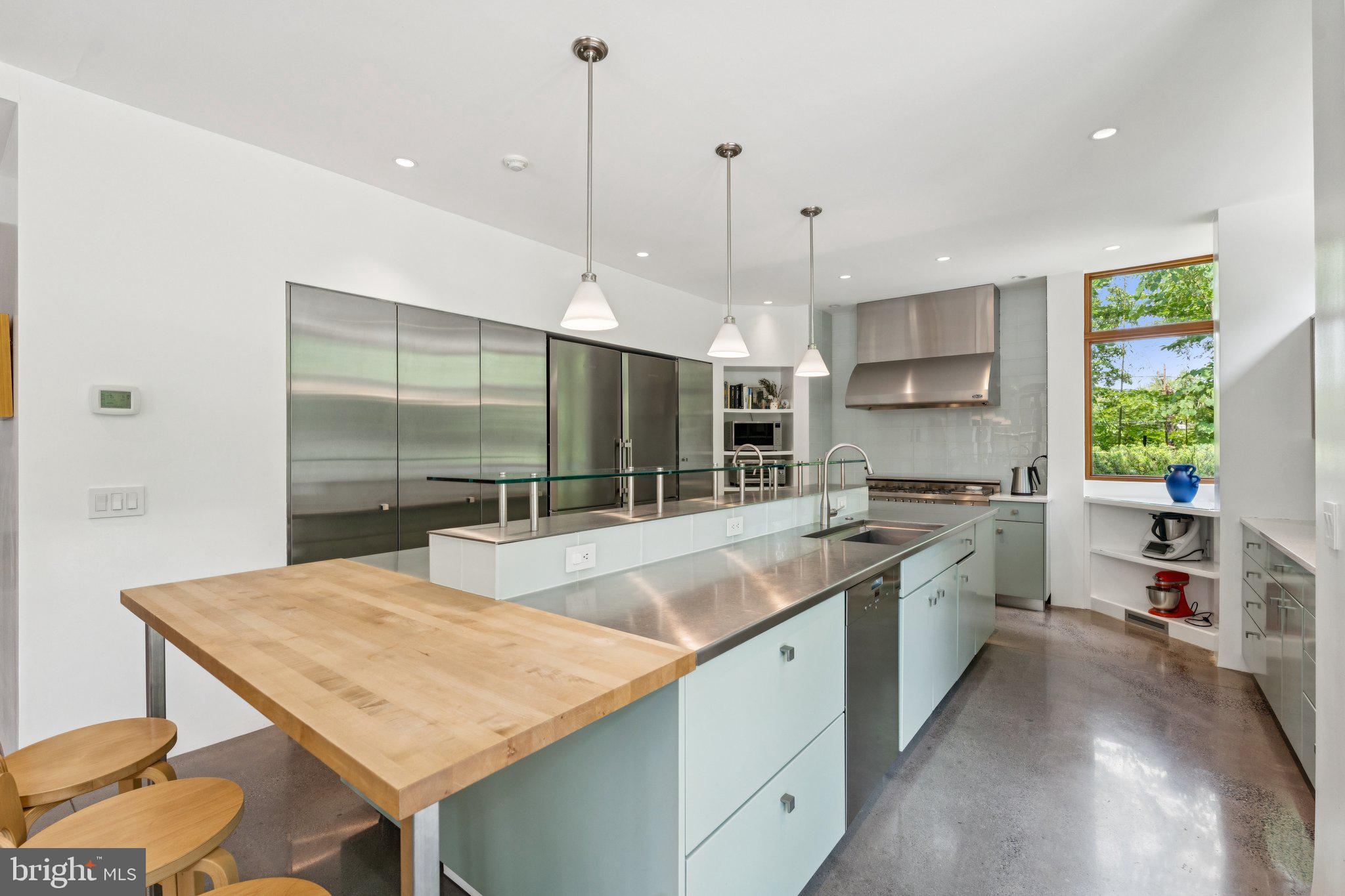 400 Chain Bridge Road McLean, VA 22101 - Photo 9 of 30 a kitchen with stainless steel appliances granite countertop a sink a stove and a wooden floors