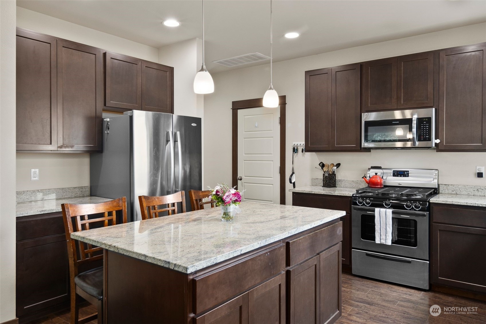 417 196th Street Southeast Bothell, WA 98012 - Photo 11 of 40 a kitchen with stainless steel appliances a sink stove refrigerator and cabinets