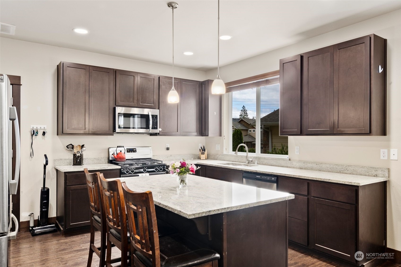 417 196th Street Southeast Bothell, WA 98012 - Photo 13 of 40 a kitchen with a table chairs sink and cabinets