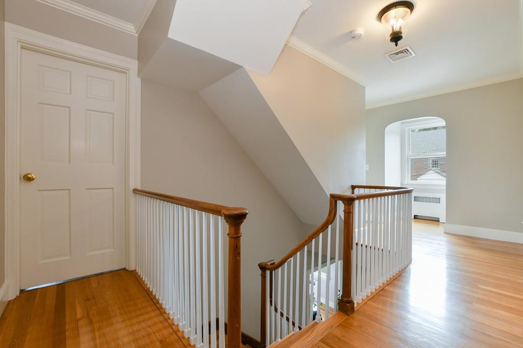 9 Hillcroft Road Boston, MA 02130 - Photo 15 of 29 a view of a hallway with wooden floor and staircase