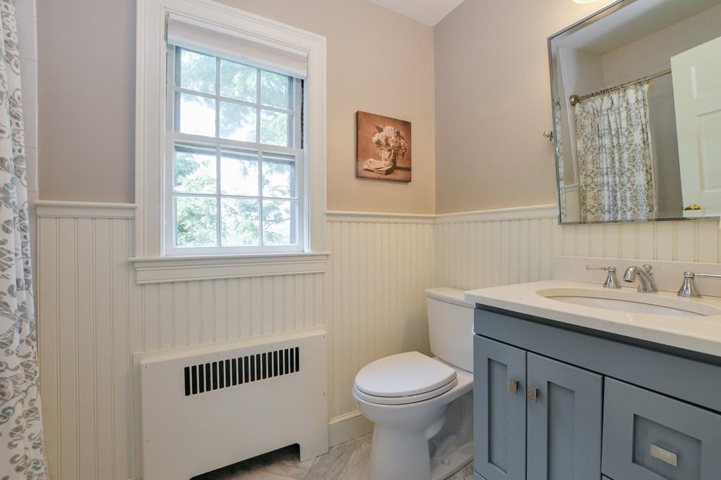 9 Hillcroft Road Boston, MA 02130 - Photo 22 of 29 a bathroom with a toilet a sink and mirror