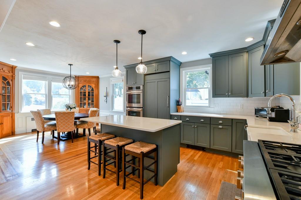 9 Hillcroft Road Boston, MA 02130 - Photo 4 of 29 a large kitchen with kitchen island a island a sink a counter space appliances and a dining table