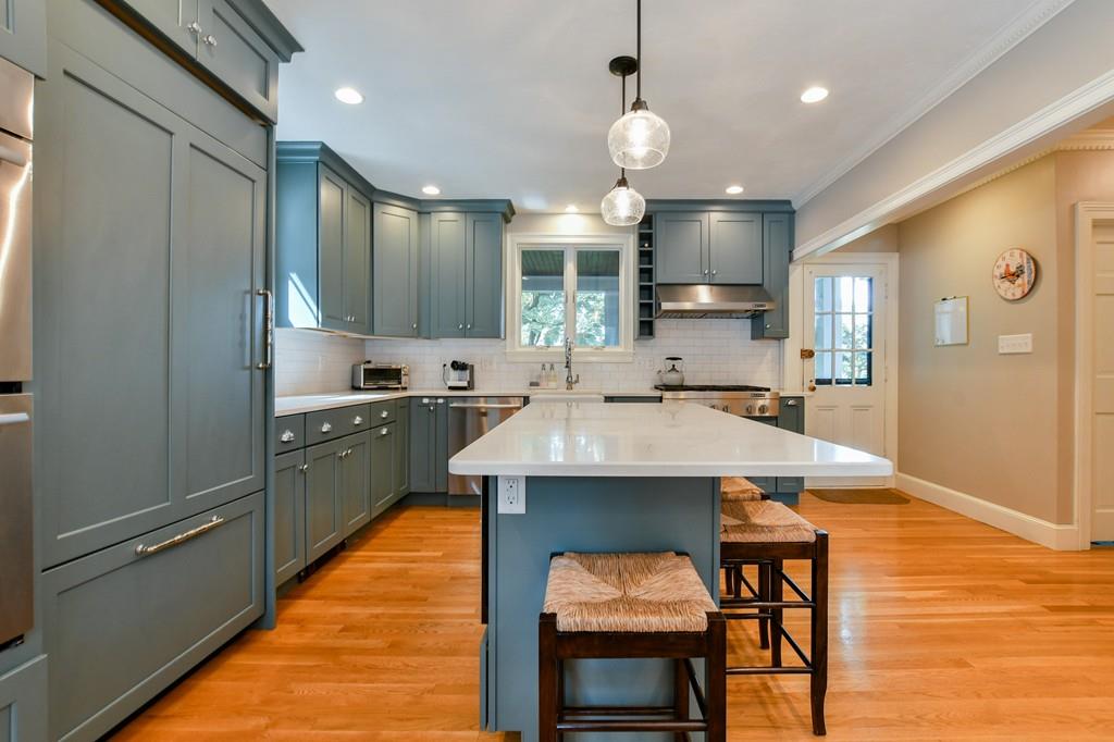 9 Hillcroft Road Boston, MA 02130 - Photo 7 of 29 a kitchen with a sink a stove cabinets and a dining table
