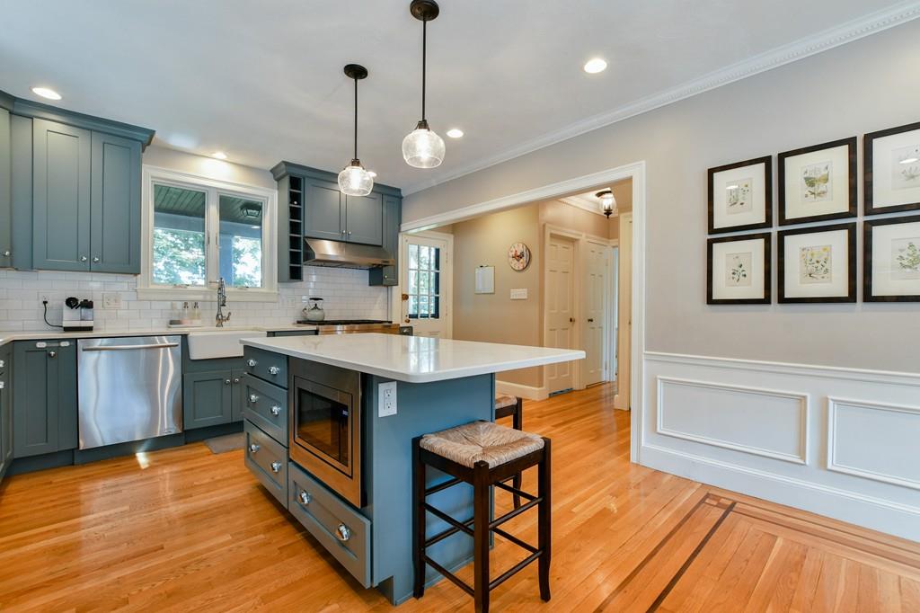 9 Hillcroft Road Boston, MA 02130 - Photo 8 of 29 a large kitchen with a stove a sink dishwasher a kitchen island with wooden cabinets and floor