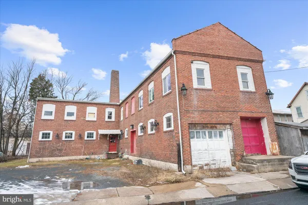 a bathroom with a granite countertop sink and bathtub