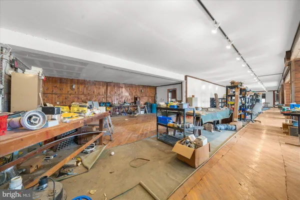 a kitchen with sink and wooden floor