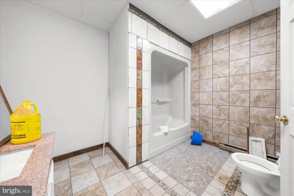 a bathroom with a toilet a sink and a window