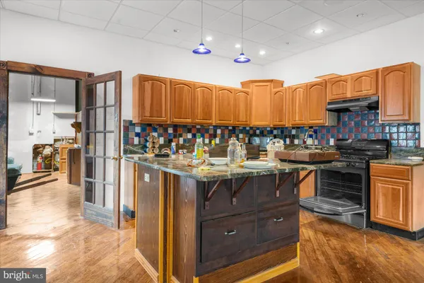 a view of a room with wooden floor